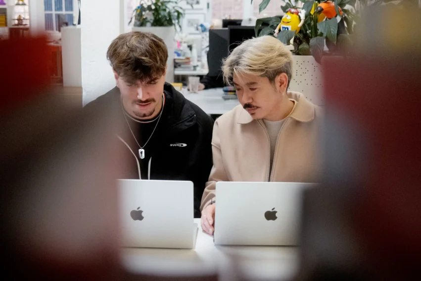 Two walterwakefield colleagues looking closely at their laptop screens while working together